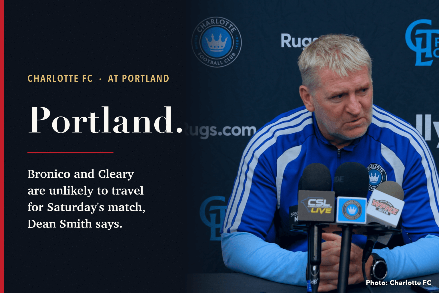 Charlotte FC head coach Dean Smith at a press conference table with microphones, in front of a club backdrop, beside a navy panel reading Portland: Bronico and Cleary are unlikely to travel for Saturday's match, Dean Smith says.