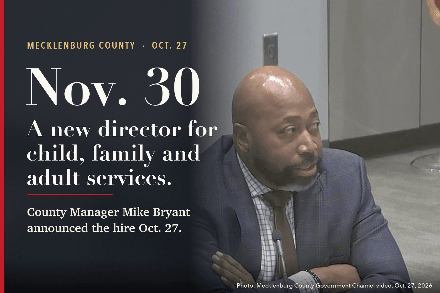 County Manager Mike Bryant at the Mecklenburg commissioners' Oct. 27 meeting, beside the words: Nov. 30. A new director for child, family and adult services.