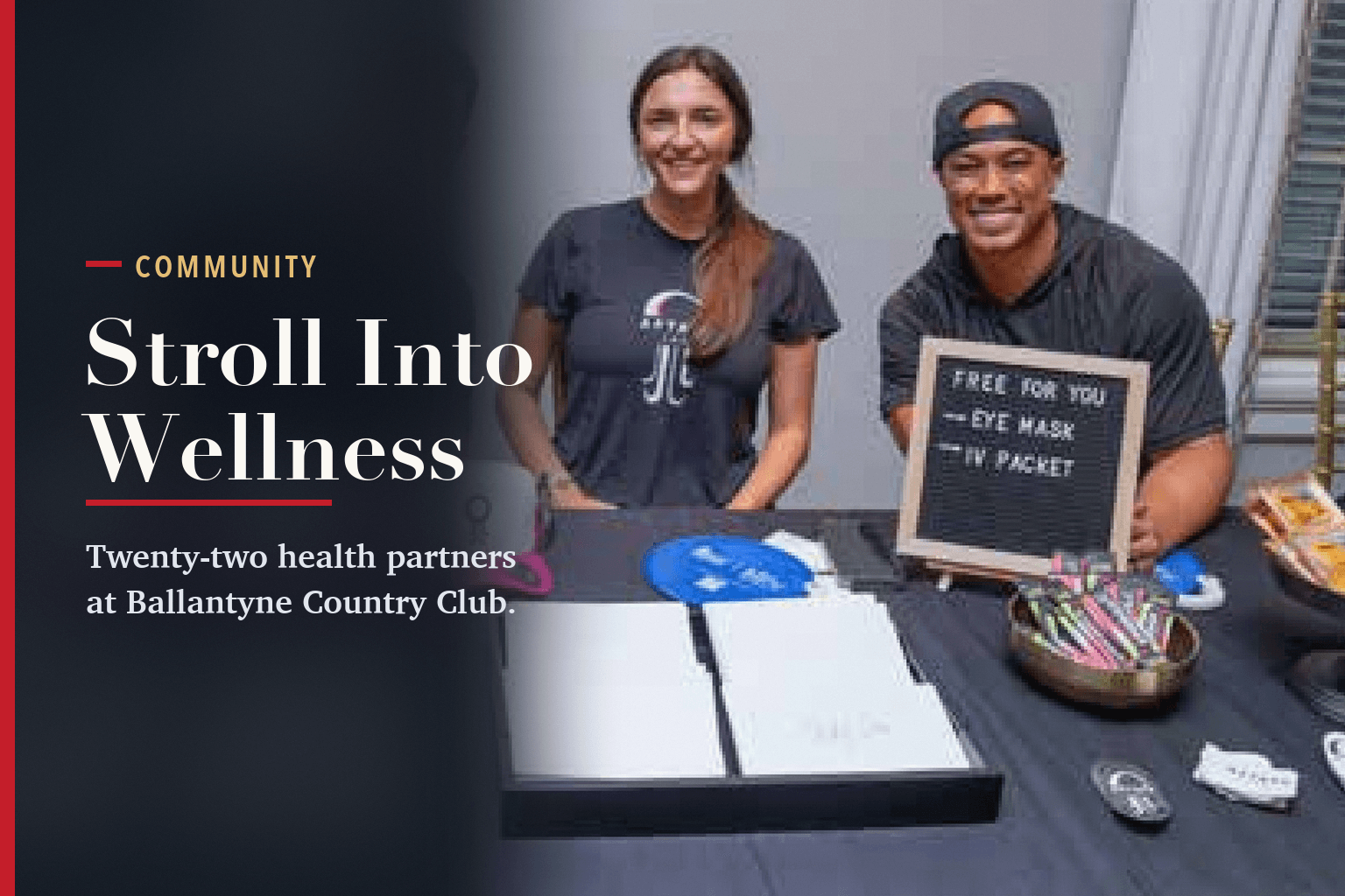 Two health partners smiling behind a table with a letter board offering a free eye mask and IV packet, beside the words Stroll Into Wellness.