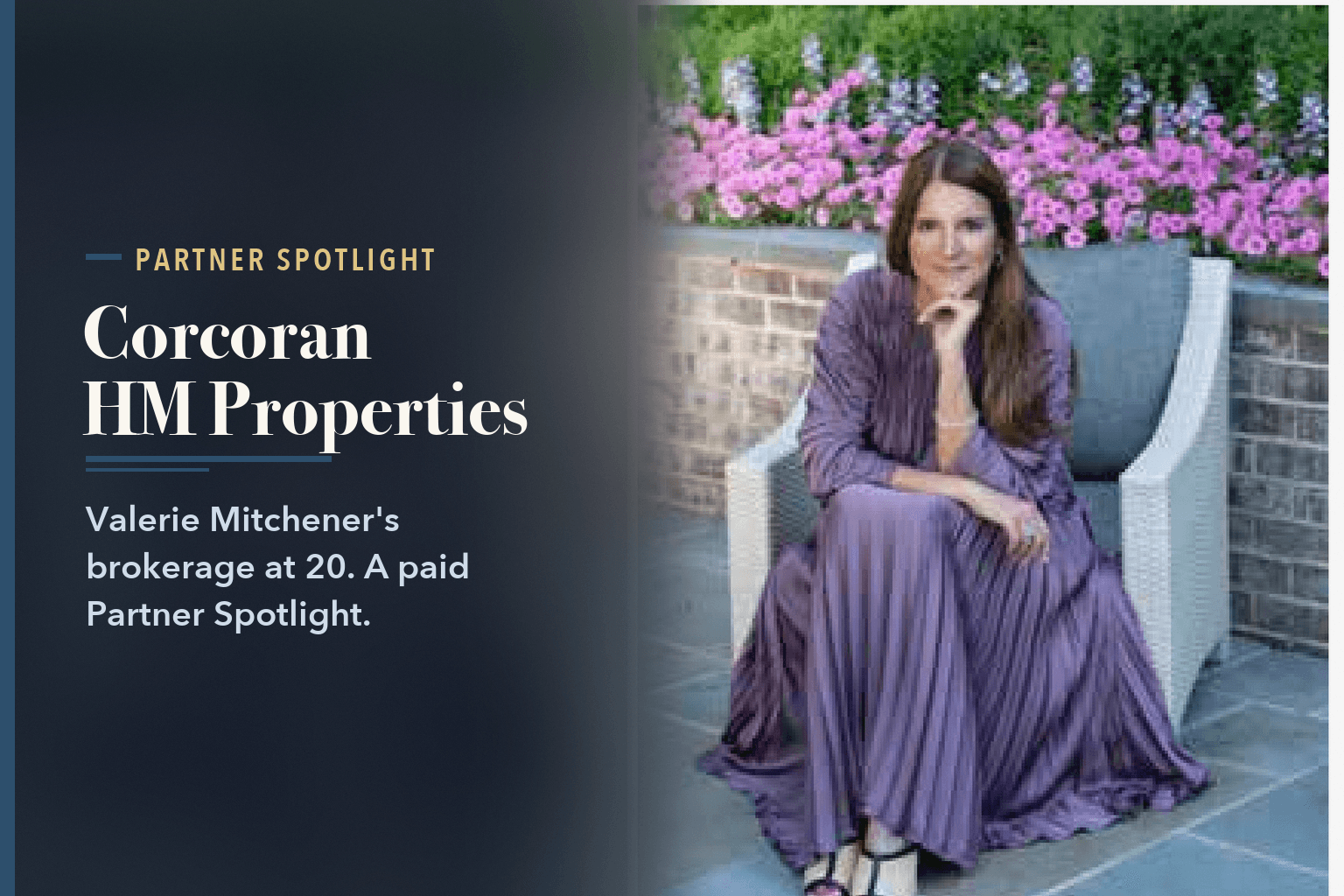Valerie Mitchener in a purple pleated dress, seated in a white outdoor chair with pink flowers behind her, beside the words Corcoran HM Properties Marks 20 Years in Charlotte.