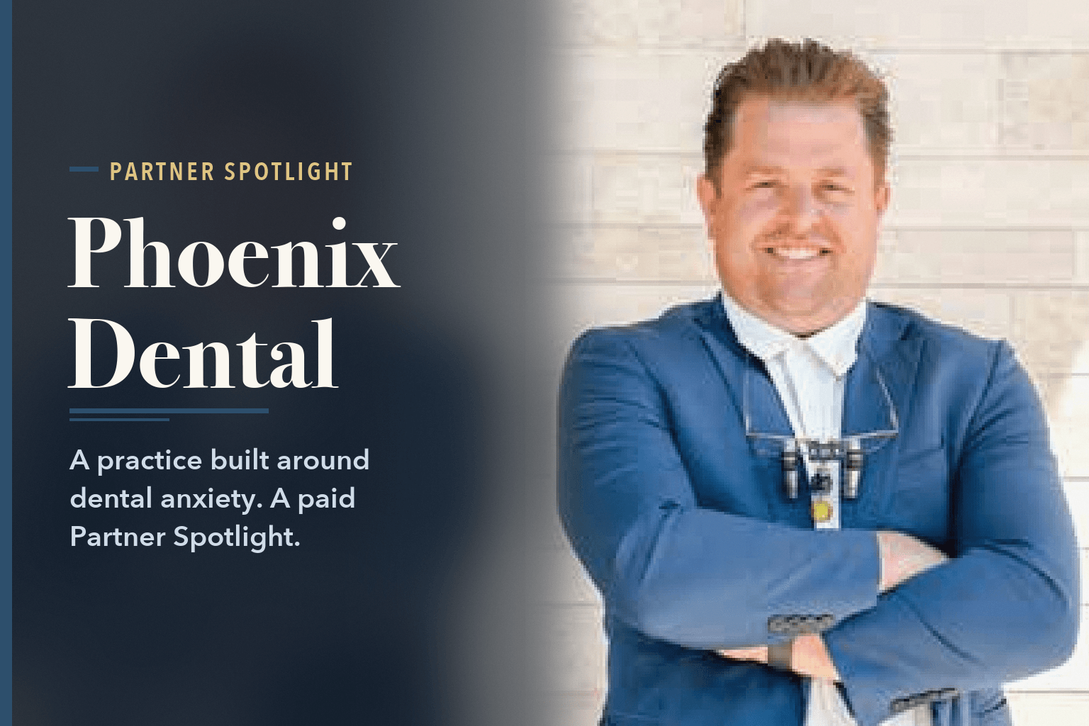A man in a blue blazer wearing dental loupes, arms crossed, in front of a stone wall, beside the words Phoenix Dental Builds a Practice Around Dental Anxiety.